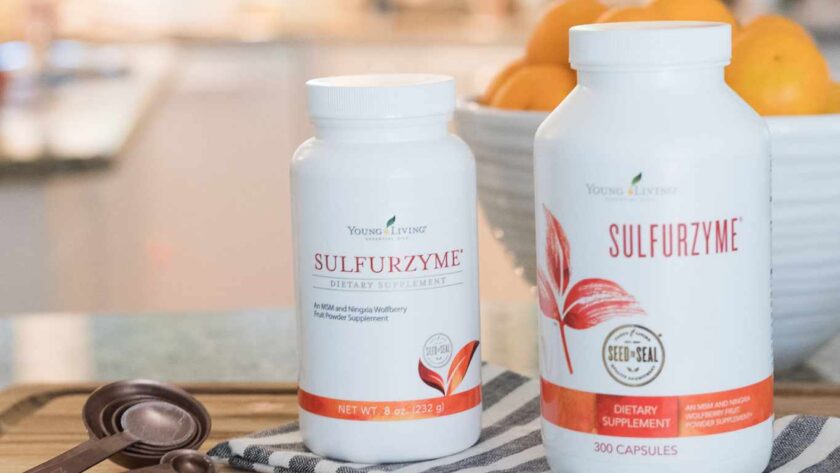 Sulfurzyme Powder and Capsules on a Counter with a window with sunlight in the background