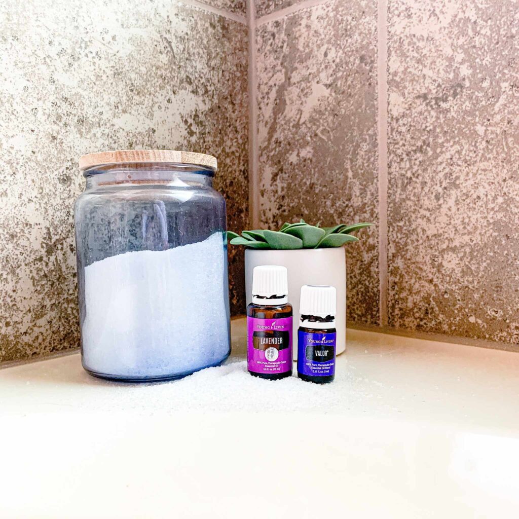 Epsom Salts Sitting on a bathtub with lavender and valor essential oil 