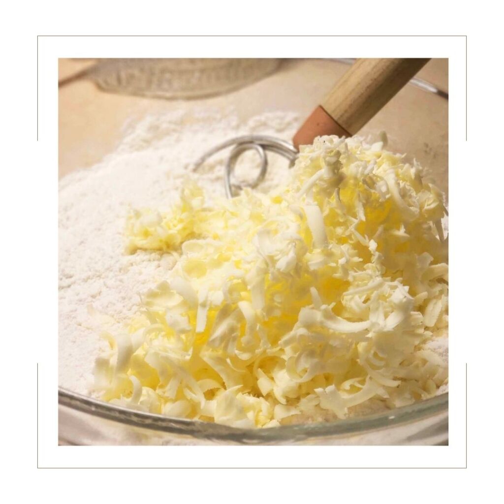 Grated butter in flour in glass bowl