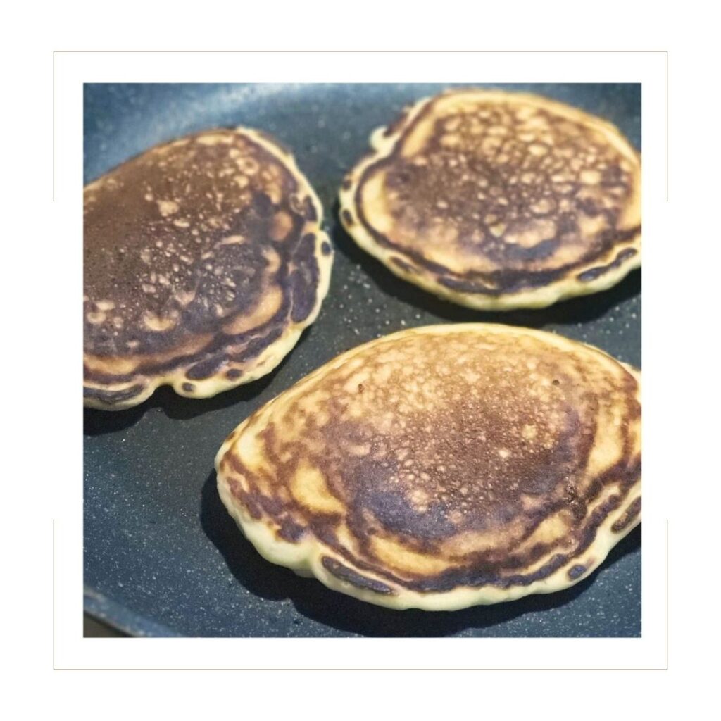 3 cooked pancakes in a skillet