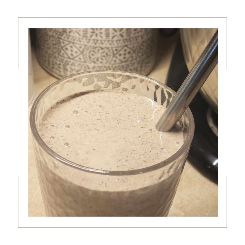 Chocolate Chip Oatmeal Cookie Smoothie in a cup with metal straw on counter