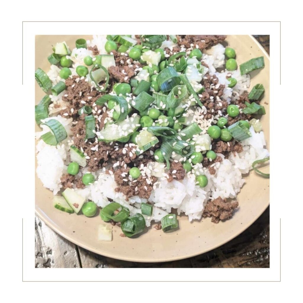 Beef Korean Bowl on tan plate.