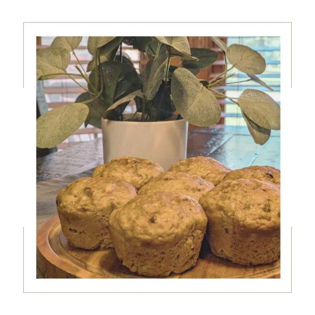 Baked Banana Nut Muffins with plant in background