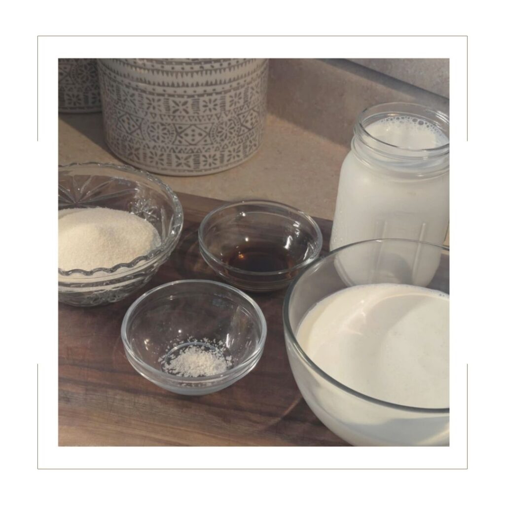 Homemade Vanilla Ice Cream Ingredients on a wooden cutting board in glass dishes