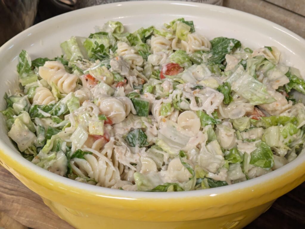 Caesar Salad Pasta Salad in a yellow bowl.