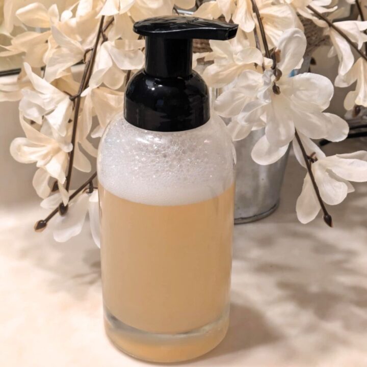 Foaming Hand Soap in Bottle with white flowers in the background
