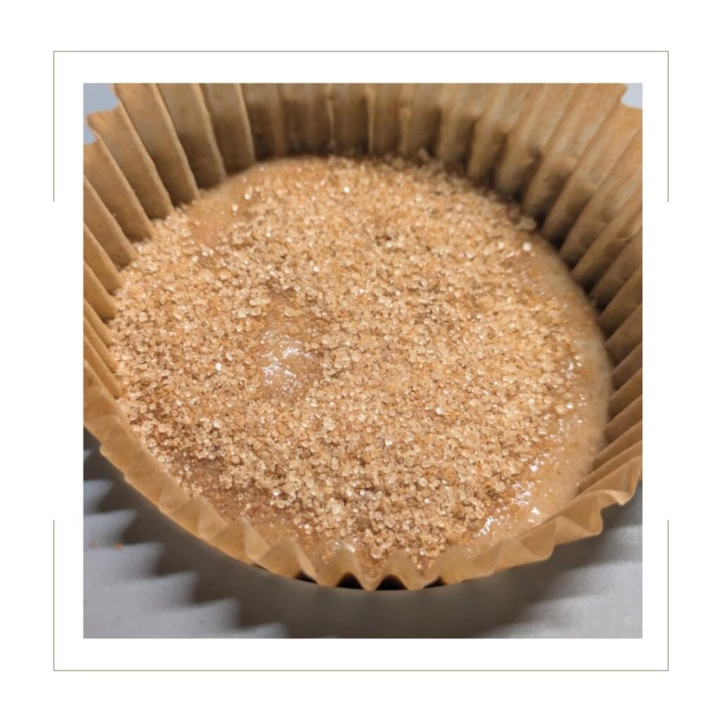 Unbaked Cinnamon Muffin with cinnamon sugar mix on top