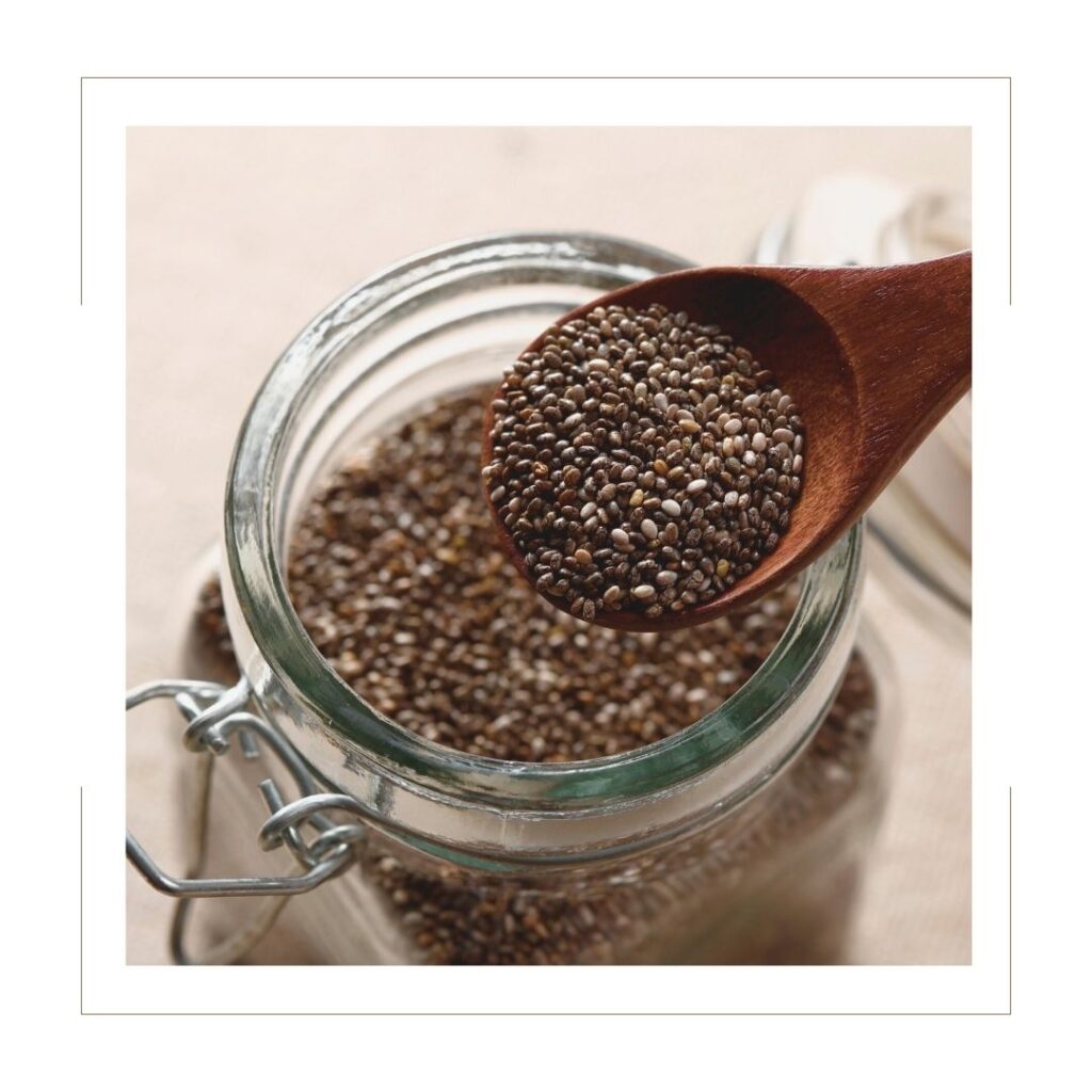 Chia Seeds in a glass jar with a wooden spoon