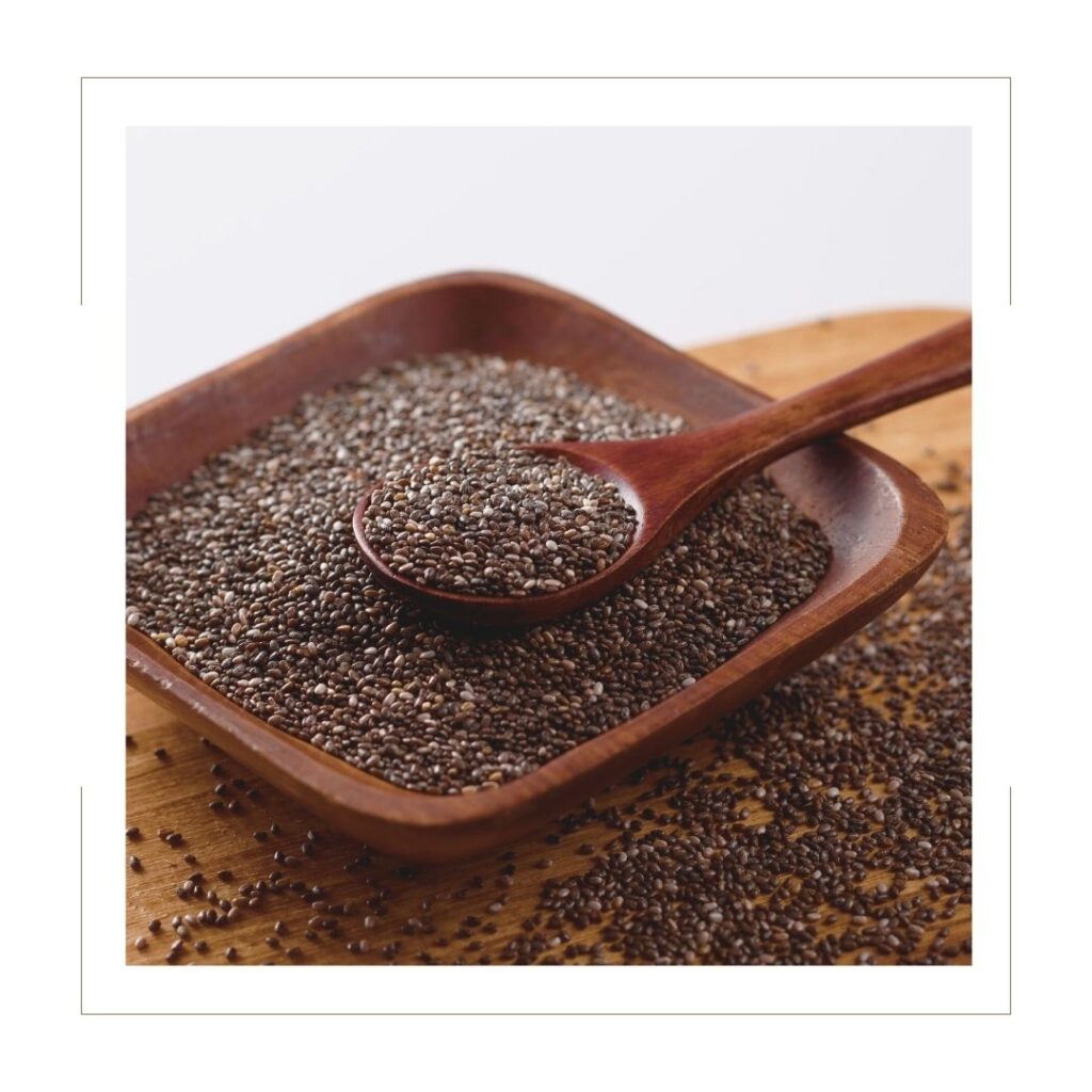 Chia Seeds in a square wooden bowl with a wooden spoon