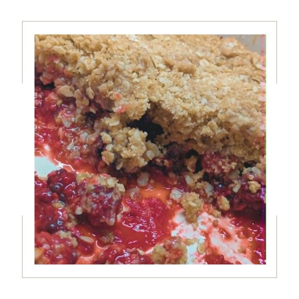 Blackberry Crisp cut into with an oat topping