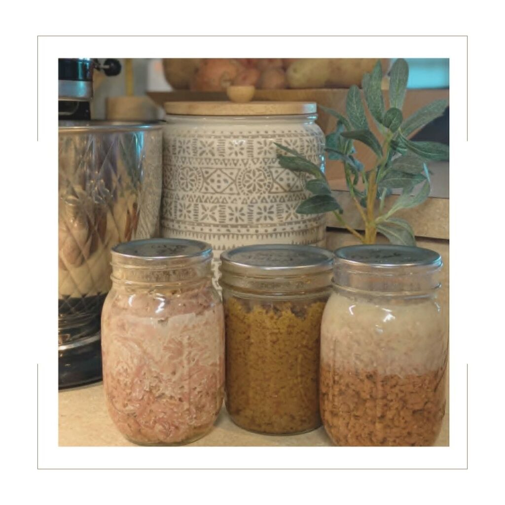 canned meat with decorative jar and plant behind it